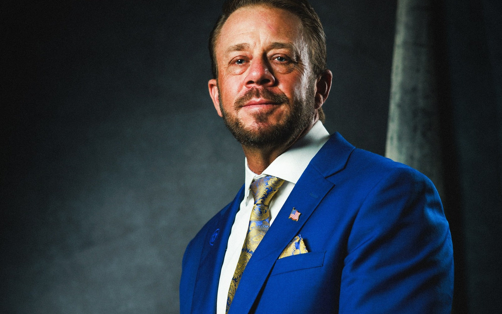 Jeremy G. Barker — founder, operator, author — portrait in blue suit
